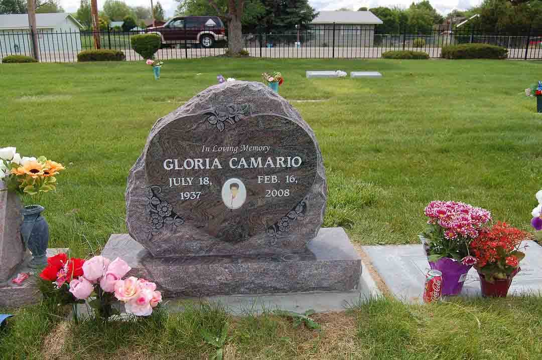 Custom-shaped granite memorial with detailed sandblast carving